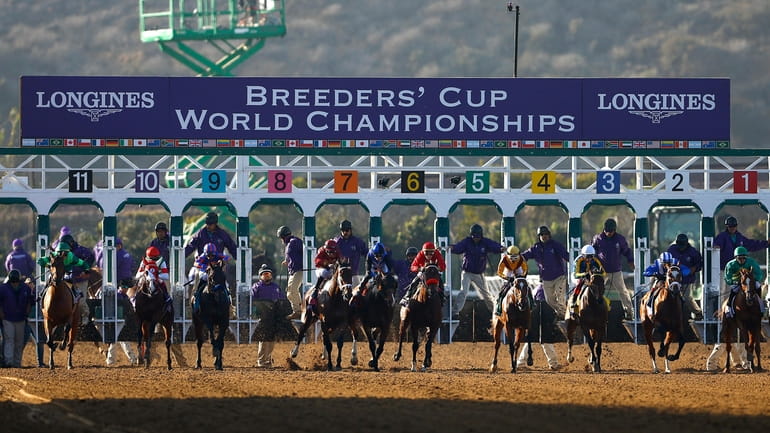 Horses break from the gate during the start of the...