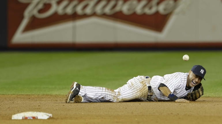 Yankees shortstop Derek Jeter reacts after injuring himself in the...