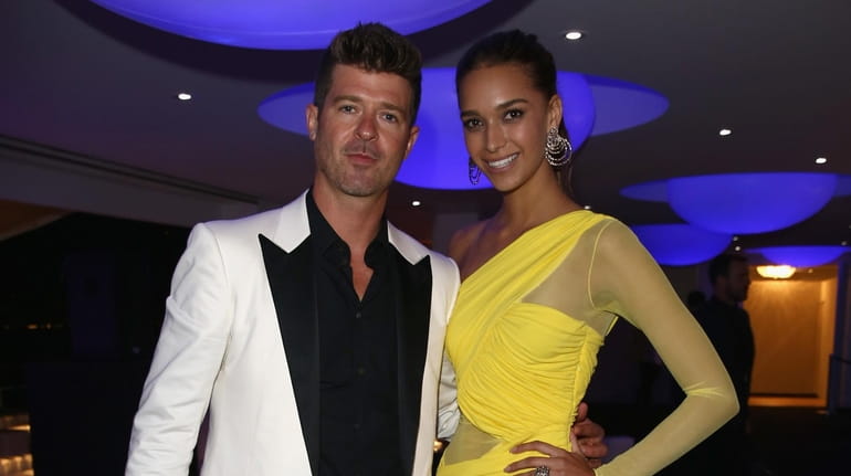 Robin Thicke and April Love Geary attend the De Grisogono...