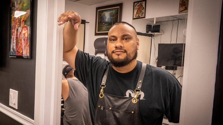 Andy Rodriguez, owner of Chupacabra Tattoo Inc. in Central Islip,...