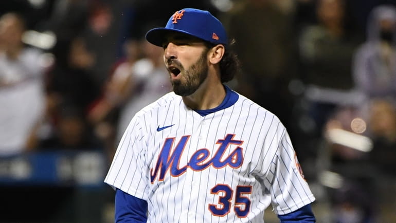 Mets relief pitcher Colin Holderman reacts after he struck out...