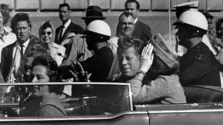 President John F. Kennedy and first lady Jacqueline Kennedy ride...