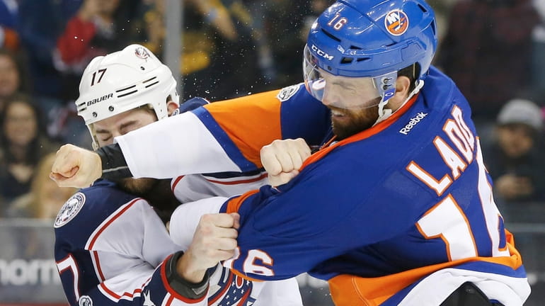 Andrew Ladd #16 of the New York Islanders fights Brandon...