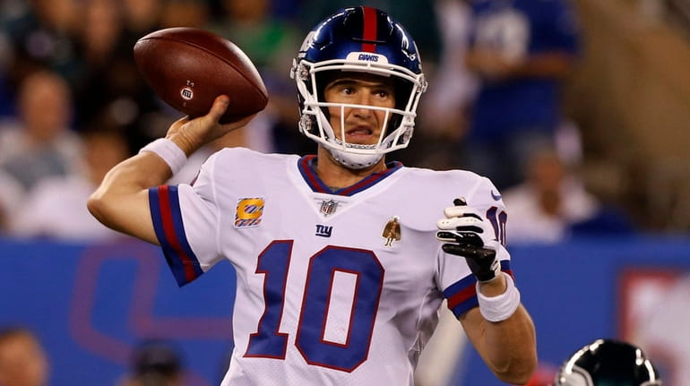Eli Manning of the Giants throws a pass in the...