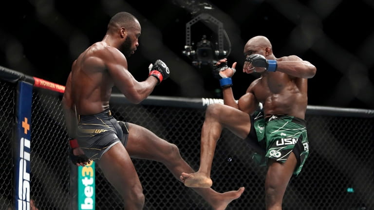 Leon Edwards, left, in action against Kamaru Usman during their...