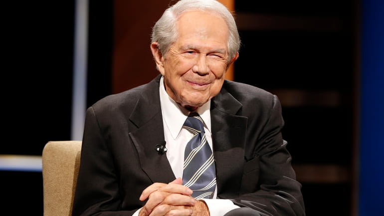 Rev. Pat Robertson poses a question to a Republican presidential...