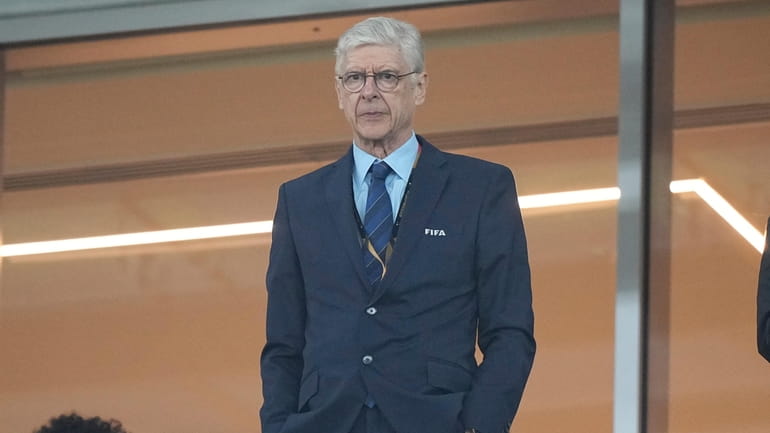 Former Arsenal coach Arsene Wenger stands on the tribune before...