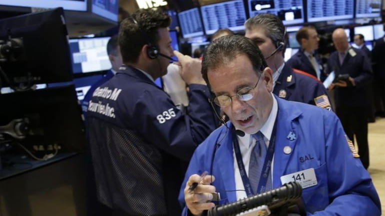 Traders work on the floor at the New York Stock...