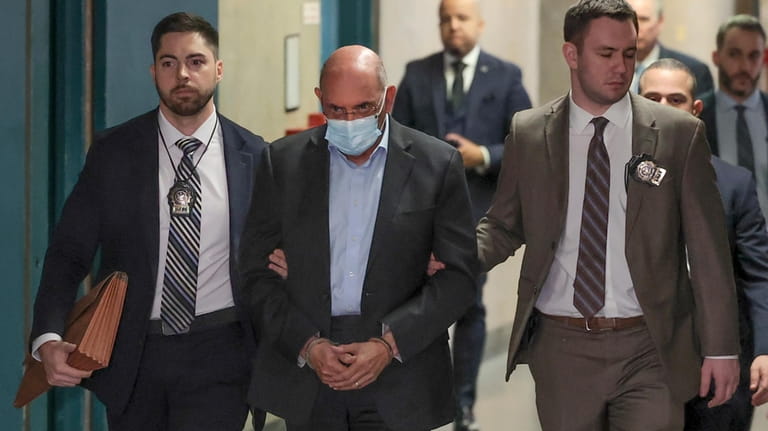 Allen Weisselberg, center, is escorted to Manhattan criminal court, Monday,...