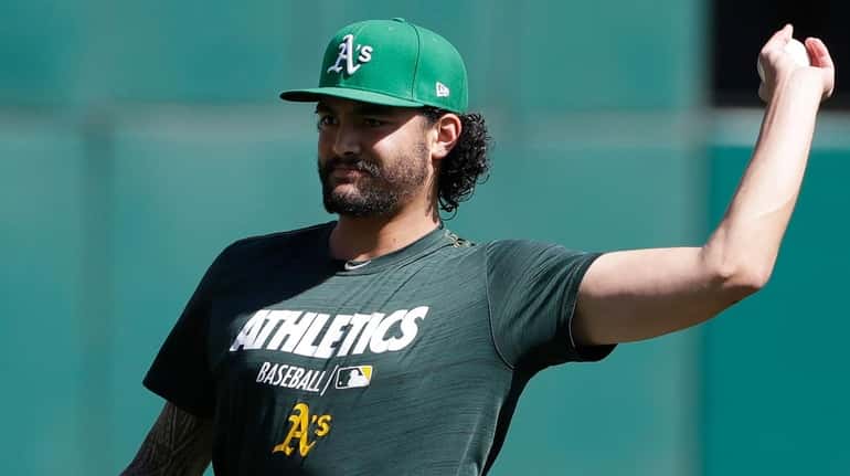 Athletics pitcher Sean Manaea throws during practice in Oakland, Calif.,...