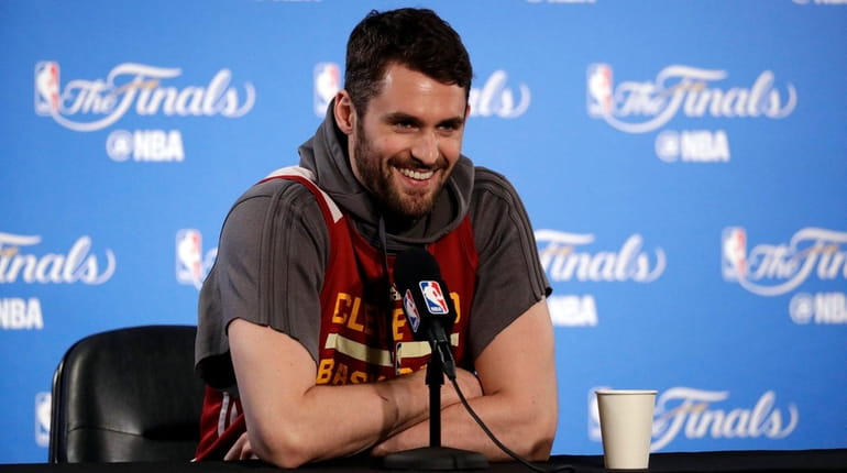 Cleveland Cavaliers' Kevin Love smiles as he fields questions before...