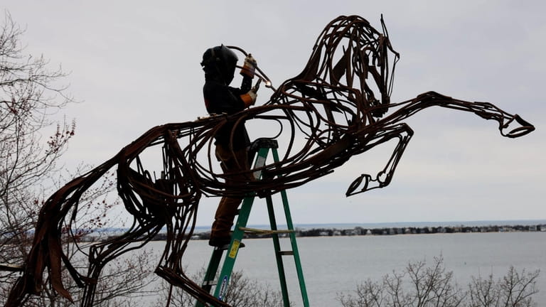 Artist Wendy Klempferer welds one of her sculptures at the...
