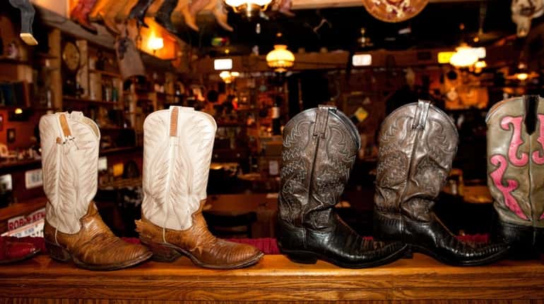 Cowboy boots, hats and other Western paraphernalia decorate the interior of...