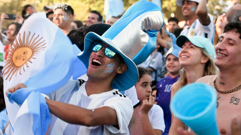 Argentine soccer fans celebrate at the end of their team's...