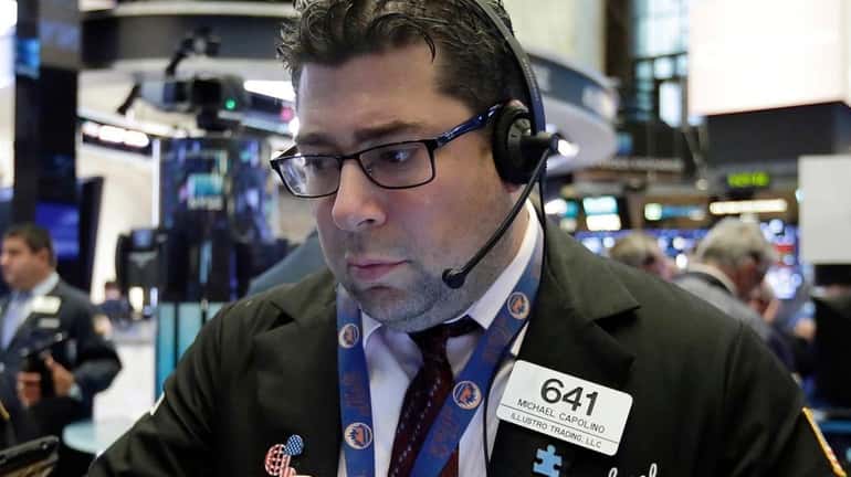 Trader Michael Capolino works at the NYSE, Aug. 16, 2017
