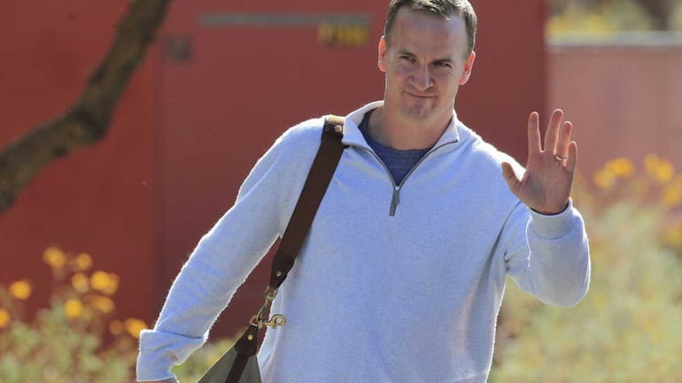 Peyton Manning leaves the Arizona Cardinals training facility after a...