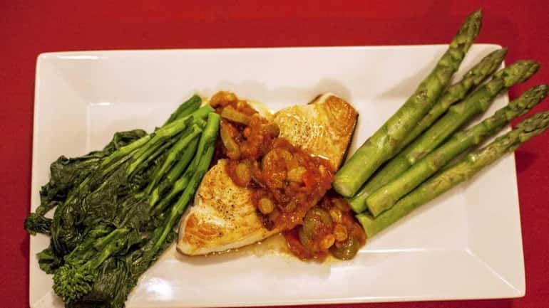 Swordfish is served with caponata, broccoli rabe and asparagus at...