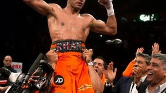 Britain's Amir Khan celebrates after beating Mexico's Julio Diaz in...