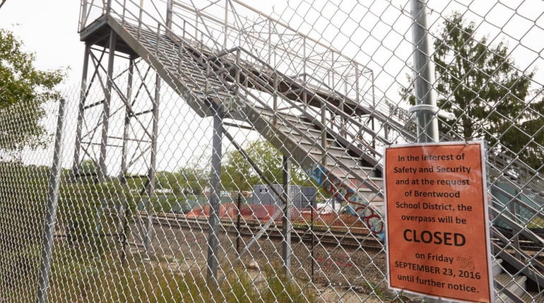 A closure sign is shown near an LIRR overpass in...