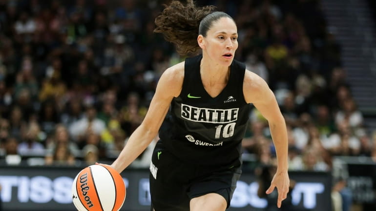 Seattle Storm guard Sue Bird brings the ball up against...