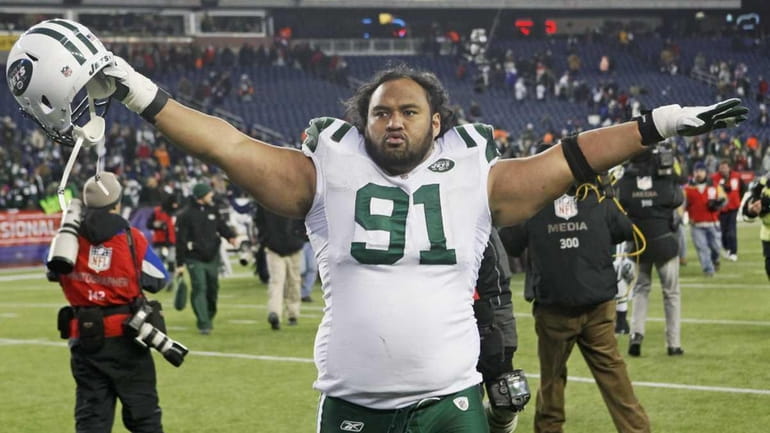 New York Jets defensive tackle Sione Pouha celebrates after the...