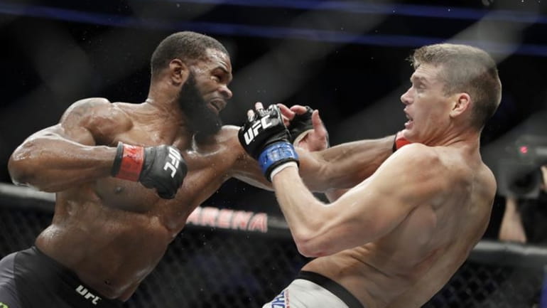 Tyron Woodley, left, hits Stephen Thompson in a welterweight championship...