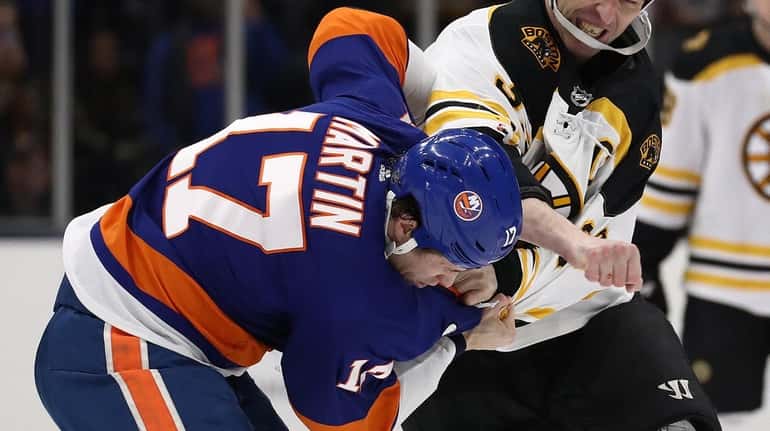 Zdeno Chara of the Bruins fights with Matt Martin of...
