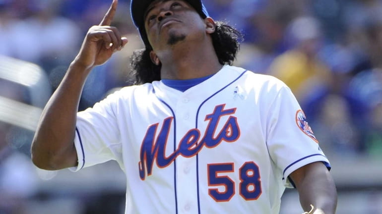 Mets pitcher Jenrry Mejia reacts at the end of the...