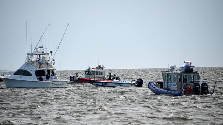 Rescue boats search for the missing boater in the Great South...