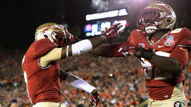 Levonte Whitfield #7 of the Florida State Seminoles celebrates with...