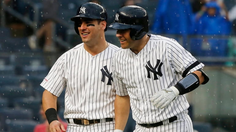 Austin Romine of the Yankees, right, celebrates his seventh-inning two-run home...