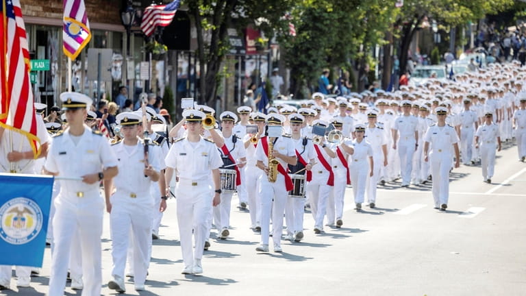 Members of the Kings Point Merchant Marine Academy march down...