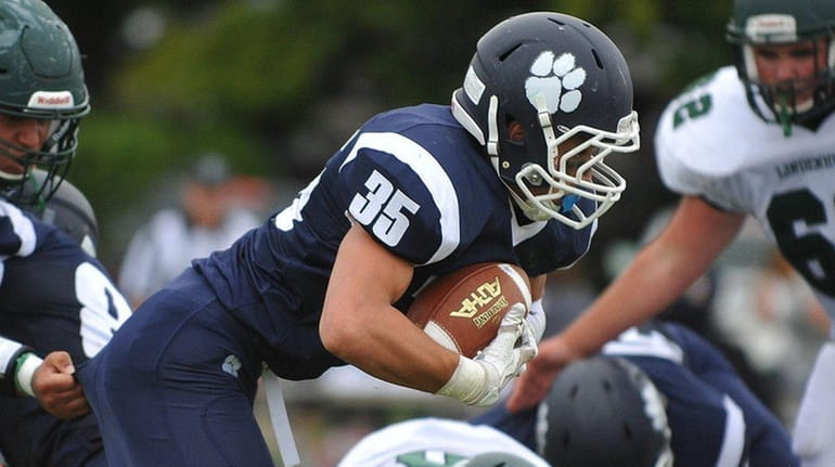 Justin Gerdvil #35 of Northport fights for yards during a...