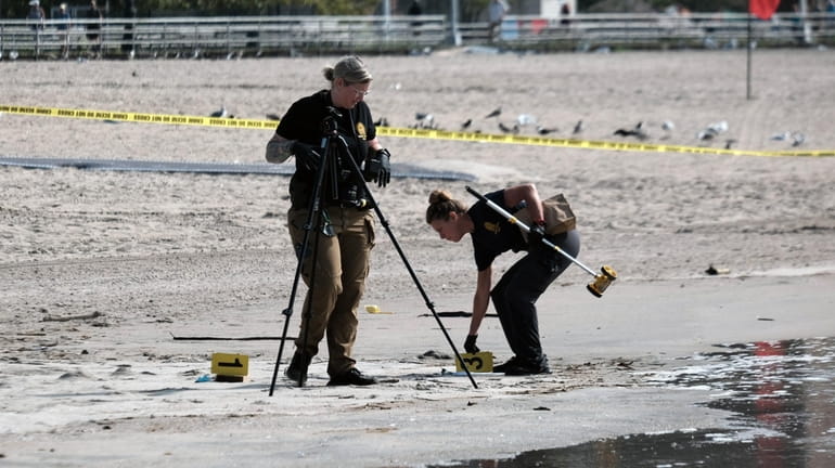 Police investigators at the scene last week in Coney Island...