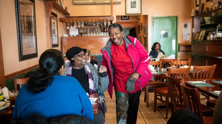 LL Dent restaurant co-owner Leisa Dent shares a laugh with customers...
