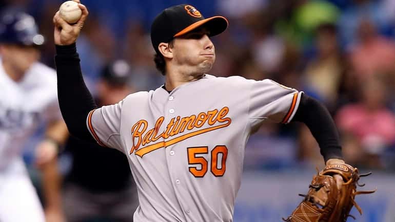 Orioles pitcher Miguel Gonzalez delivers a pitch during a game...