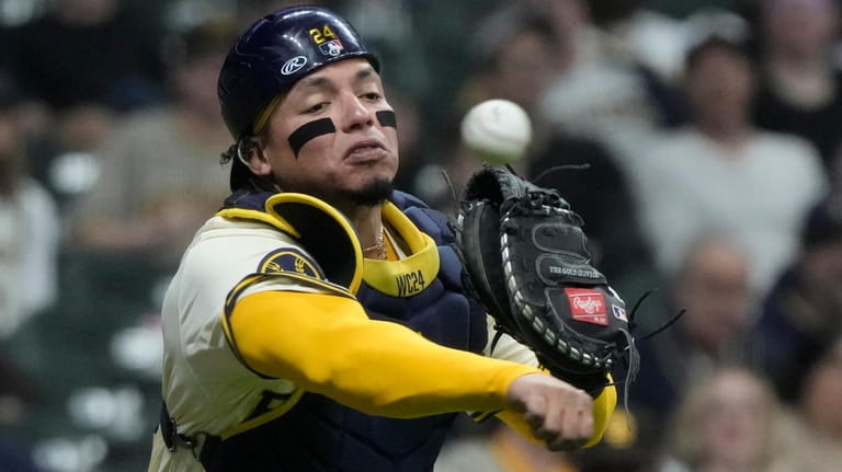 Milwaukee Brewers catcher William Contreras makes a play on a...