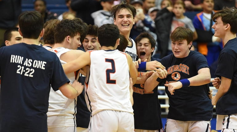 Manhasset teammates celebrate after their win over Kings Park in...