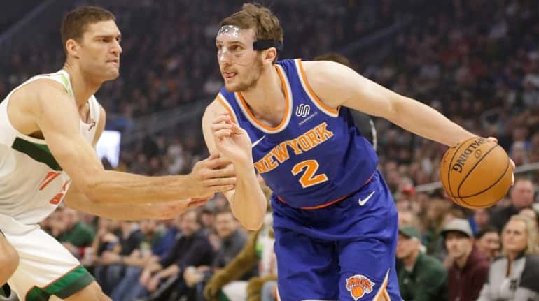 New York Knicks' Luke Kornet drives against Milwaukee Bucks' Brook...