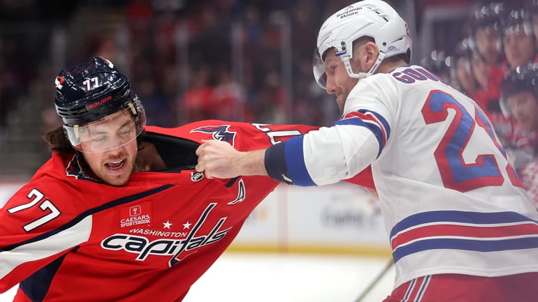 T.J. Oshie of the Capitals and Barclay Goodrow of the Rangers fight during...