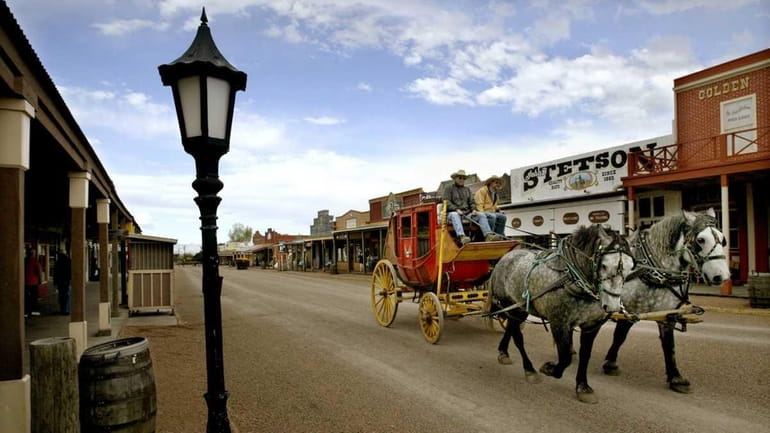 A stagecoach takes visitors on a tour around downtown Tombstone,...
