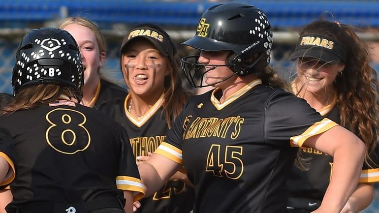 Jaclyn Morra #45, St. Anthony's shortstop, second from right, celebrates...