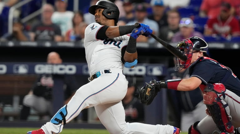 Miami Marlins' Jean Segura (9) hits a double during the...