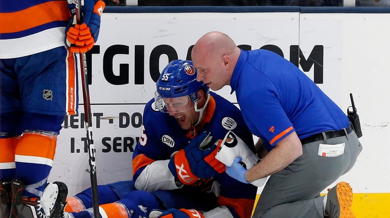 Johnny Boychuk of the New York Islanders reacts after being hit...