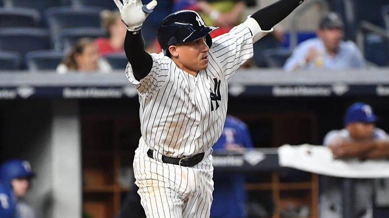 New York Yankees shortstop Ronald Torreyes reacts after he hits...