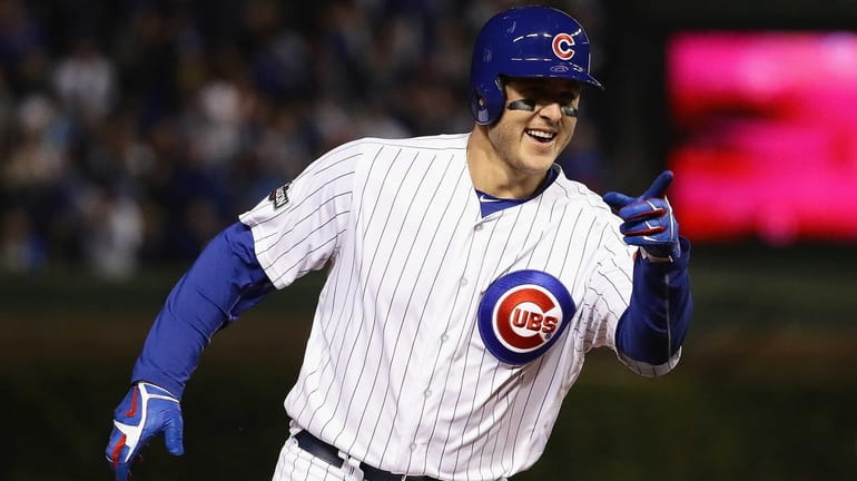 Anthony Rizzo #44 of the Chicago Cubs reacts as he...
