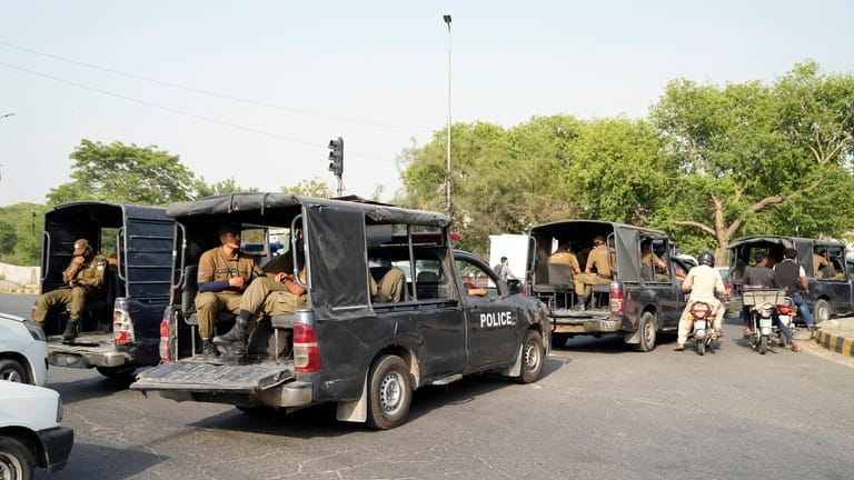 Police officers patrol around the home of Pakistan's former Prime...