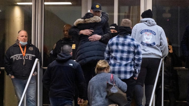 NYPD personnel and others gather at Harlem Hospital after a...