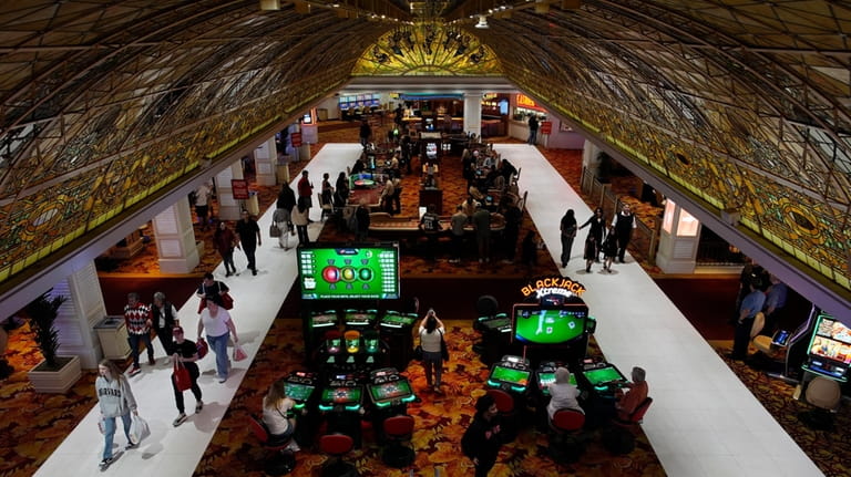 People walk through the casino floor at the Tropicana hotel-casino...