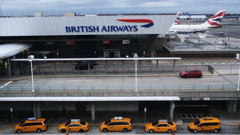 Taxis wait for passengers at Kennedy Airport in Queens in...